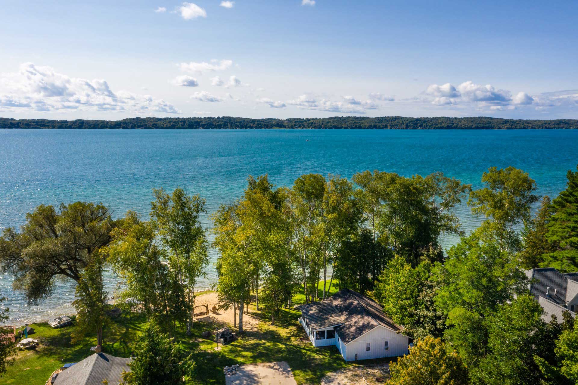 Aerial photo of Torch Lake by Birch Cottage Cabin at Water Camp